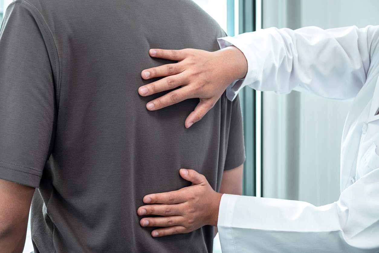 Doctor examines a patient's back.