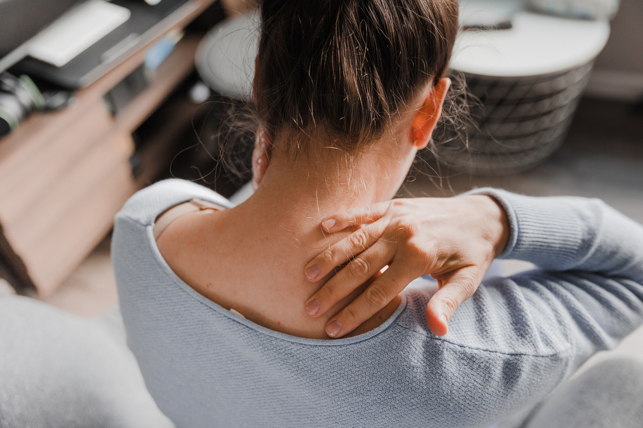 Woman massaging her stiff neck