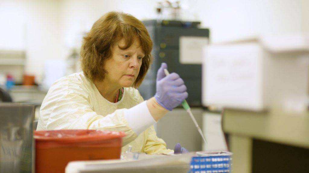 Woman scientist working with droplets for her testing.